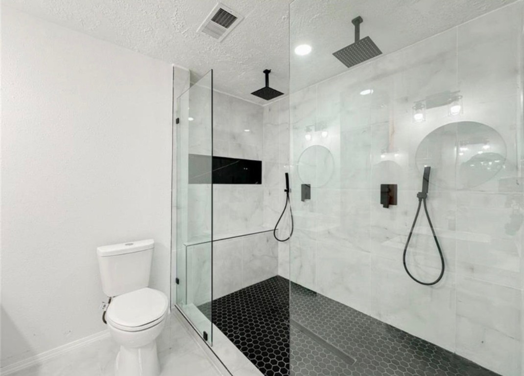 7311 Fuchsia Lane Humble, TX 77346 - Photo 35 of 38 a bathroom with a granite countertop sink a toilet and a shower
