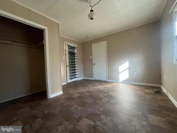 a view of a livingroom with an empty space and a window