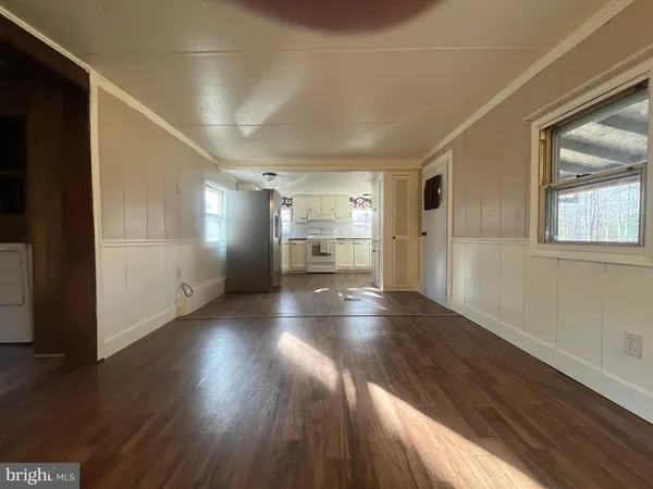 a view of empty room with wooden floor