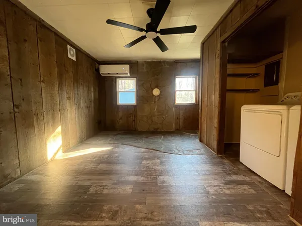 a view of an empty room with a kitchen