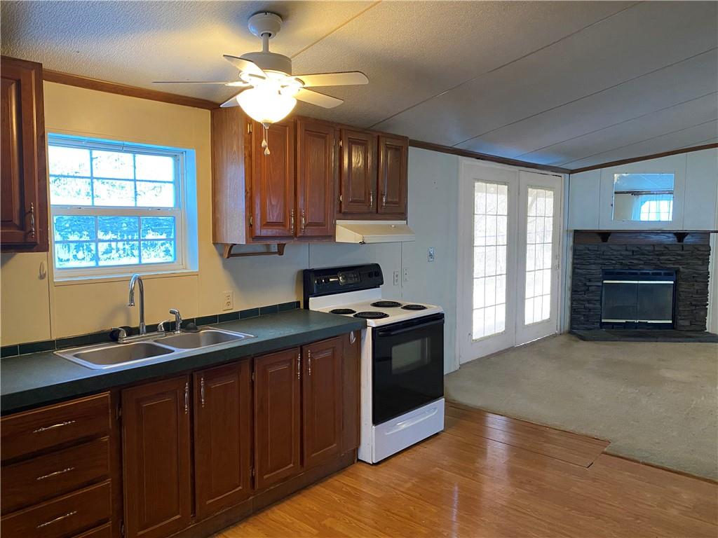 82 Old Brick Road West Alexander, PA 15376 - Photo 6 of 17 a kitchen with granite countertop a stove a sink and a microwave