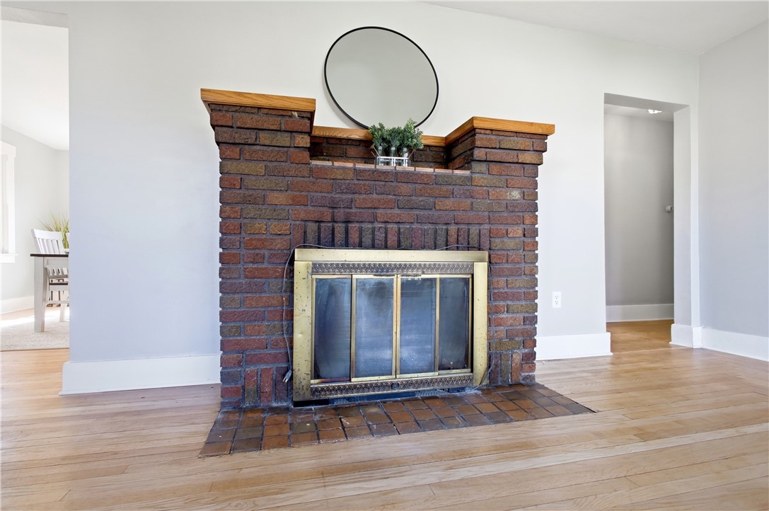 1925 Sunset Avenue Springfield, OH 45505 - Photo 9 of 45 This living area features a robust brick fireplace, grounding the space with warmth and character.