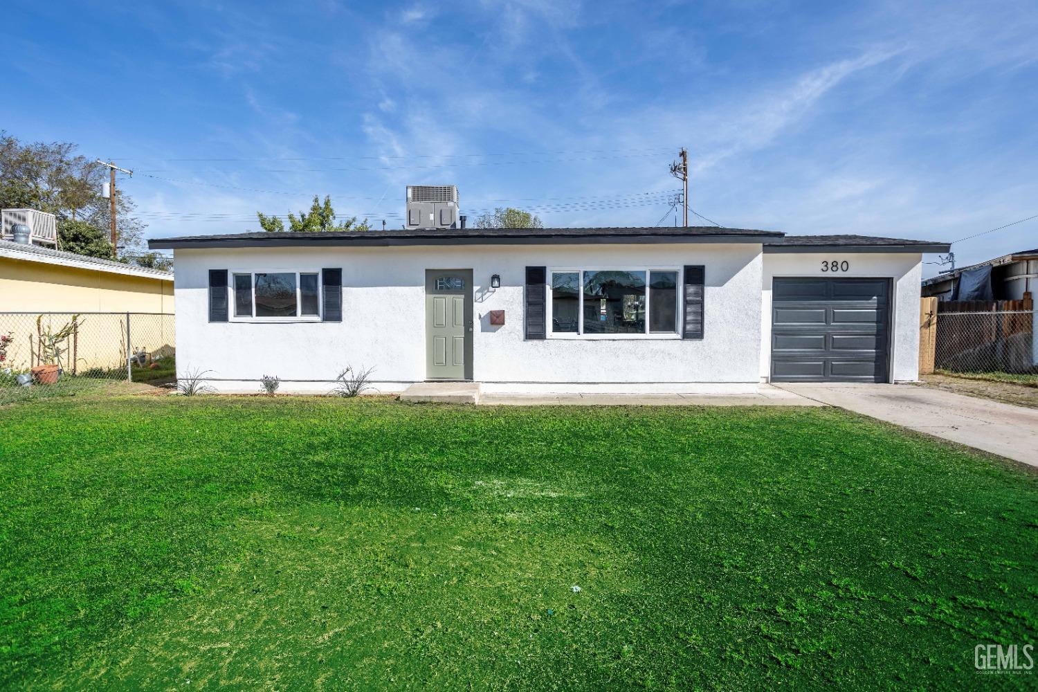 Undisclosed Address Shafter, CA 93263 - Photo 1 of 18 a front view of house with yard and green space