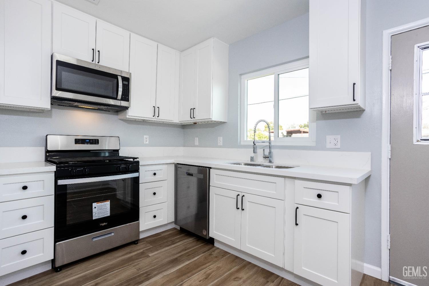 Undisclosed Address Shafter, CA 93263 - Photo 11 of 18 a kitchen with stainless steel appliances white cabinets a sink and a stove