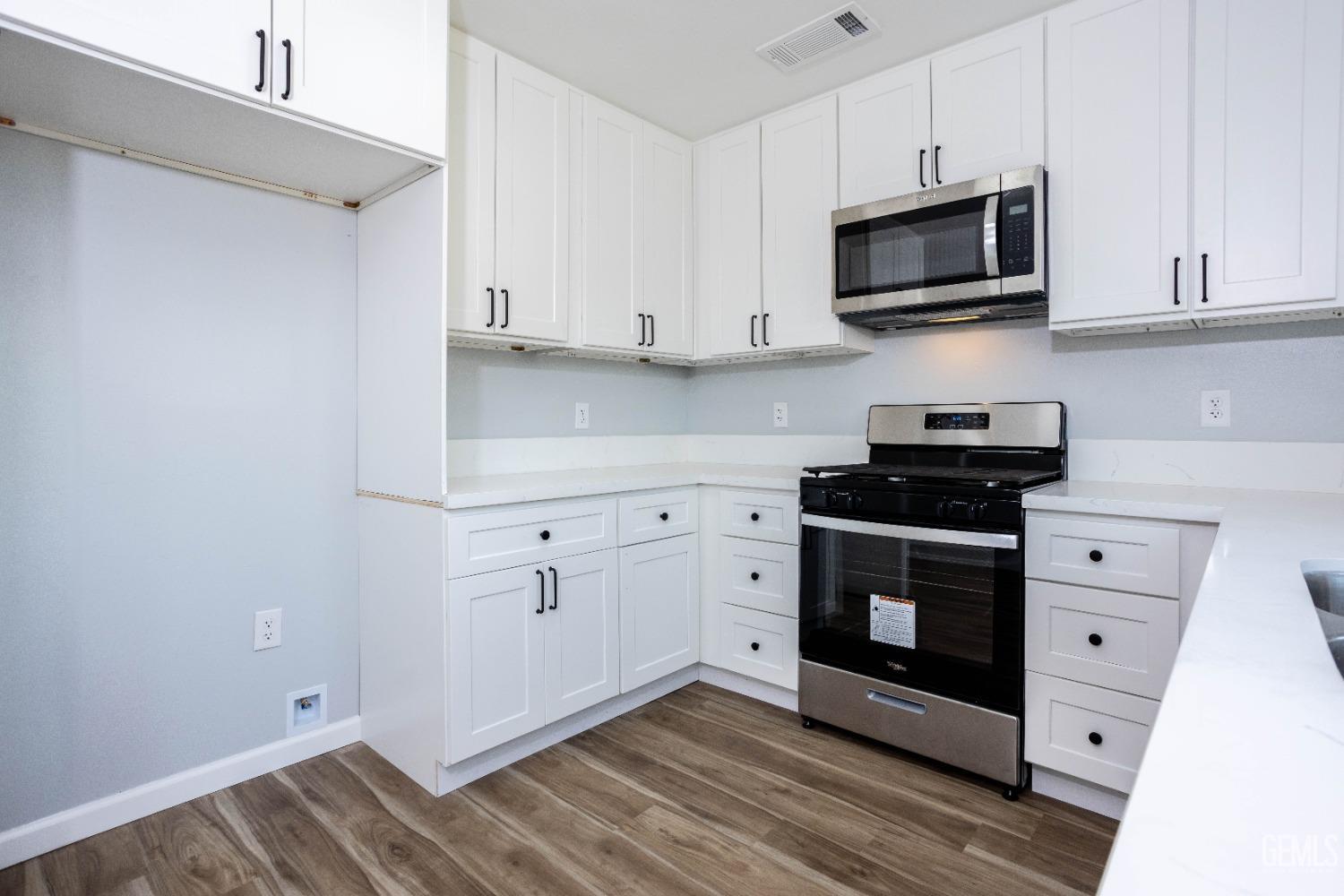 Undisclosed Address Shafter, CA 93263 - Photo 12 of 18 a kitchen with stainless steel appliances a stove microwave and cabinets