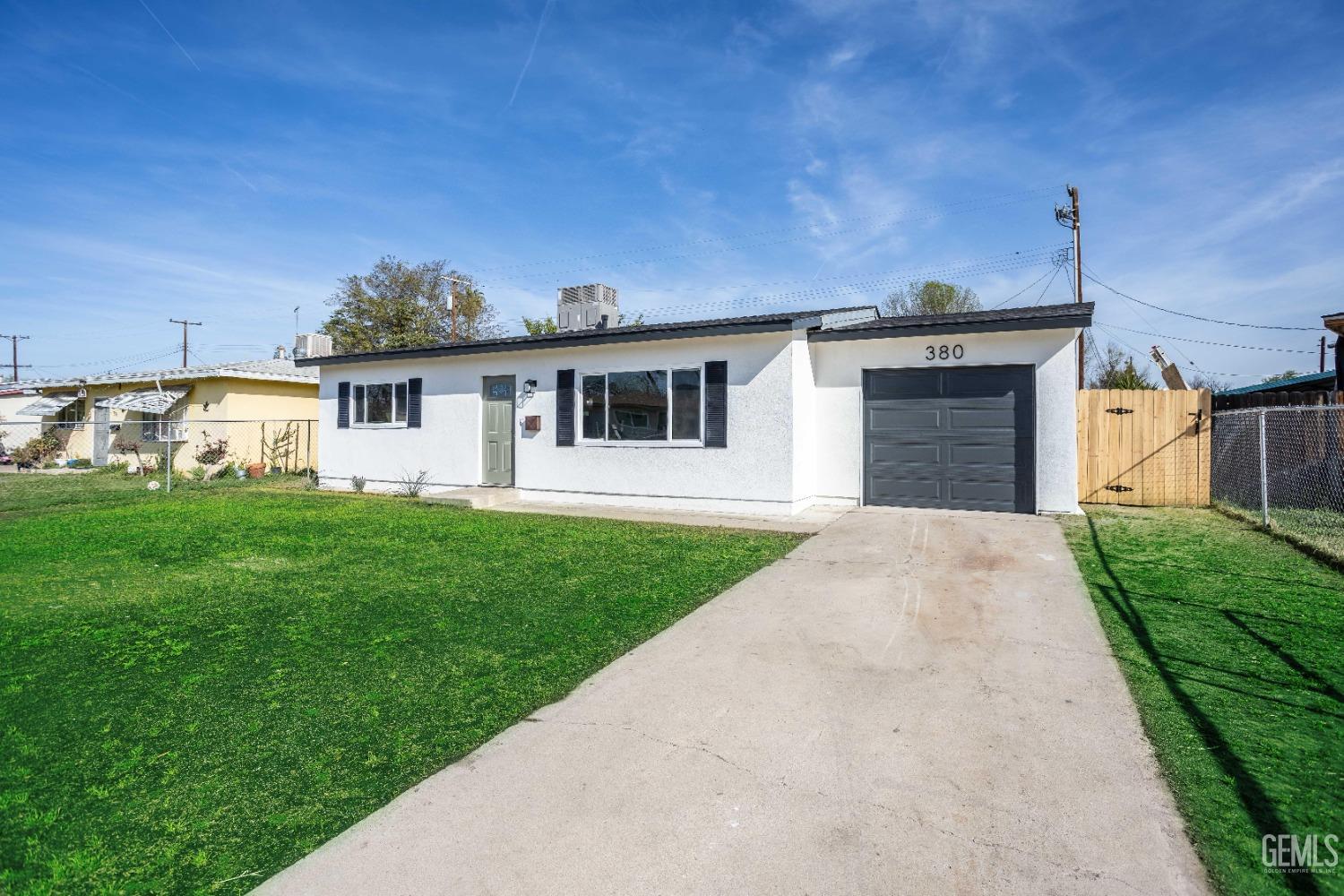 Undisclosed Address Shafter, CA 93263 - Photo 2 of 18 a front view of a house with a yard and garage