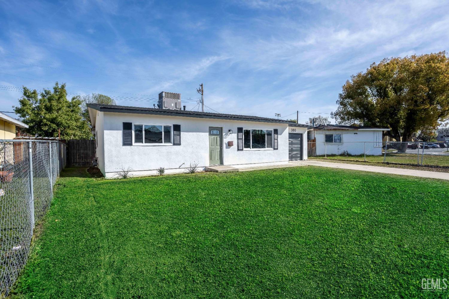 Undisclosed Address Shafter, CA 93263 - Photo 3 of 18 a front view of house with yard and green space