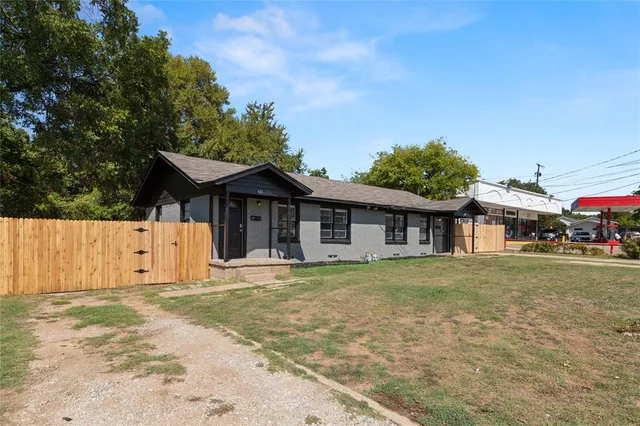 a white house that has a tree in front of it