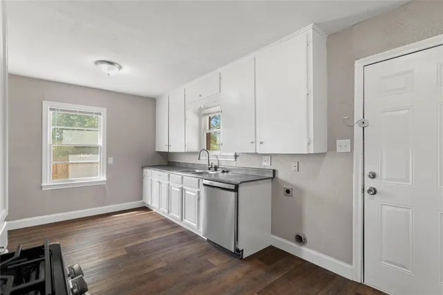 a kitchen with stainless steel appliances granite countertop white cabinets stove and sink