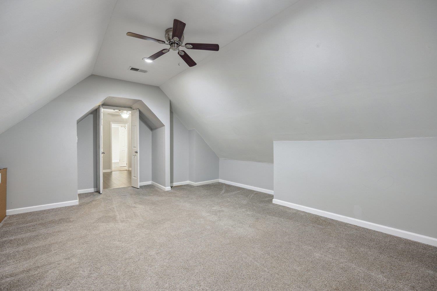 8747 Walnut Grove Road Memphis, TN 38018 - Photo 16 of 20 an empty room with a ceiling fan and window
