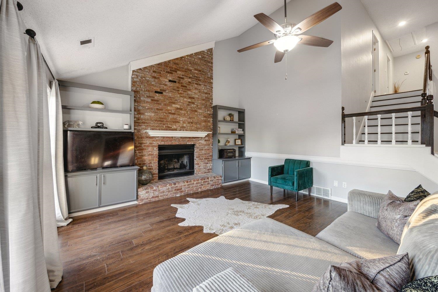 8747 Walnut Grove Road Memphis, TN 38018 - Photo 8 of 20 a living room with furniture a fireplace and a flat screen tv