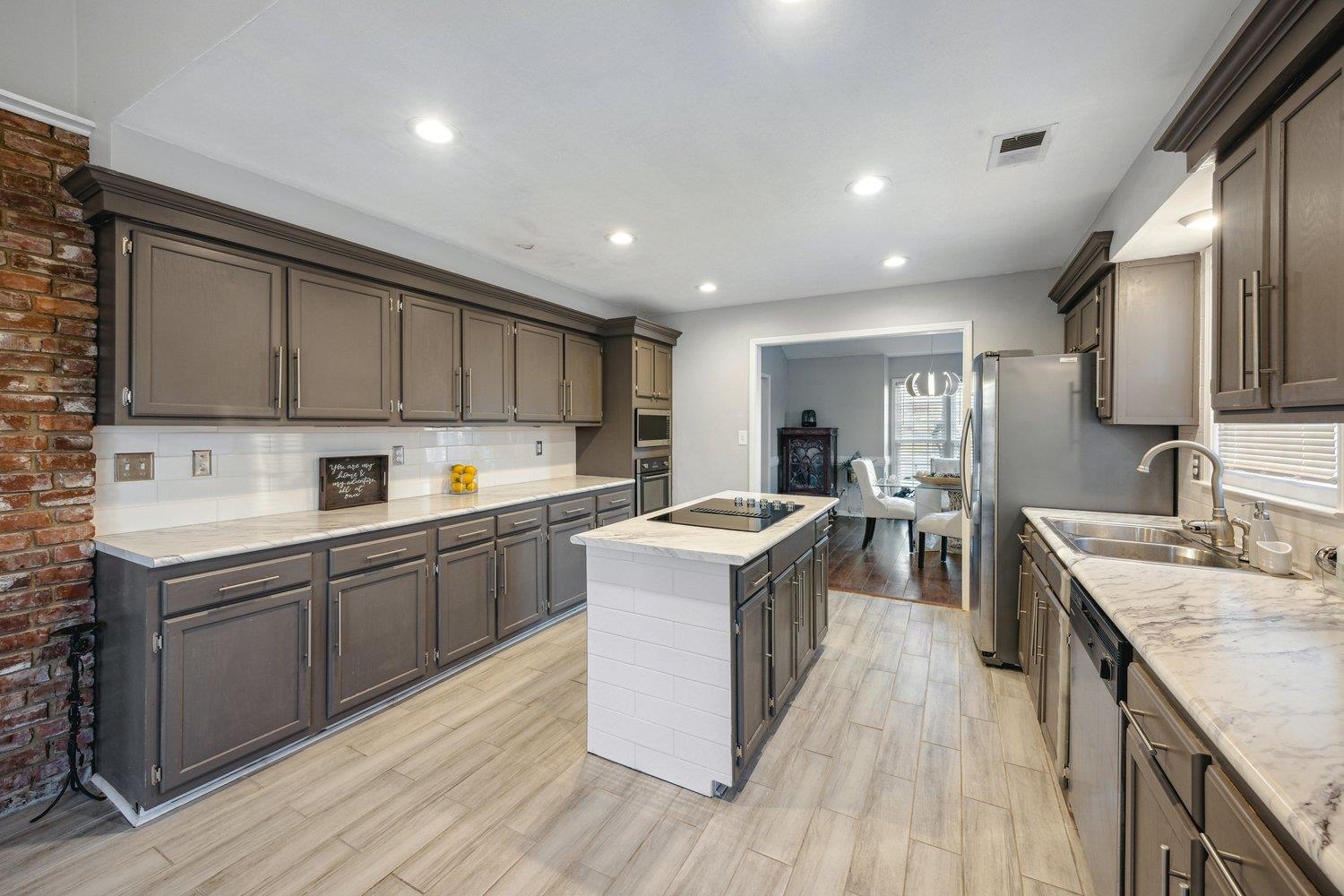 8747 Walnut Grove Road Memphis, TN 38018 - Photo 9 of 20 a kitchen with stainless steel appliances granite countertop wooden cabinets a sink dishwasher a stove and a refrigerator