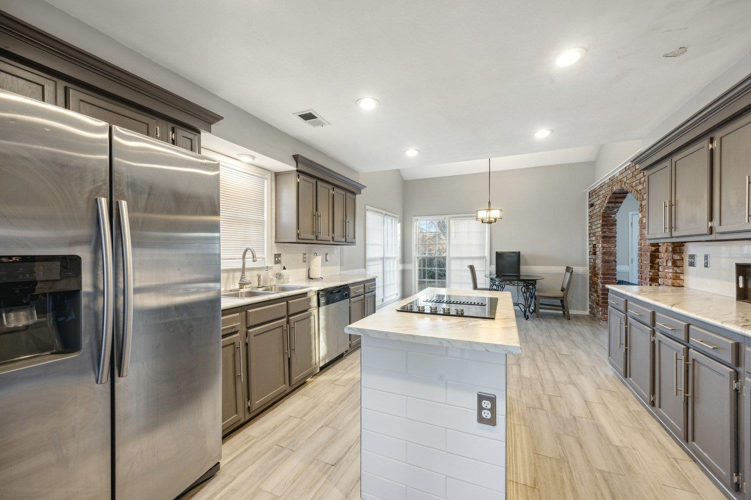 8747 Walnut Grove Road Memphis, TN 38018 - Photo 10 of 20 a kitchen with stainless steel appliances granite countertop a refrigerator a stove and a sink