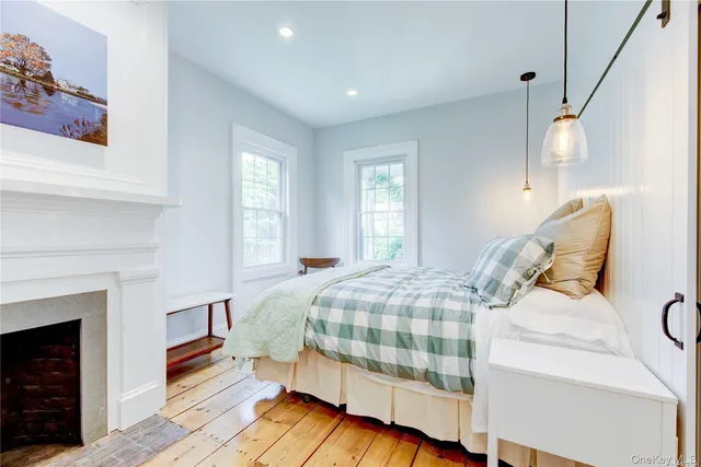 a bedroom with a bed and a fireplace