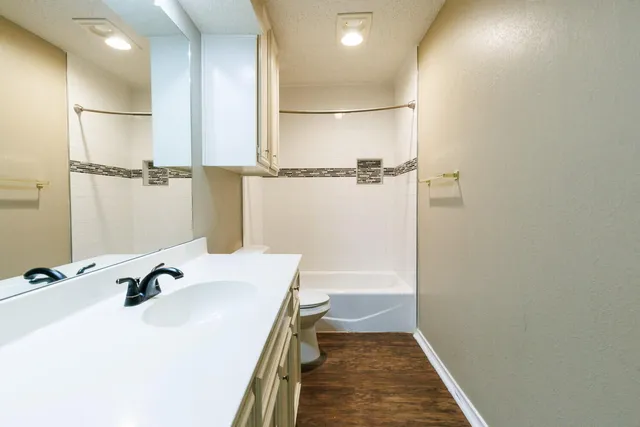 an empty room with a bathroom and a sink