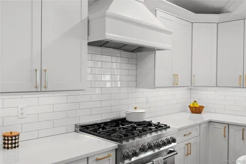 a kitchen with a stove and cabinets