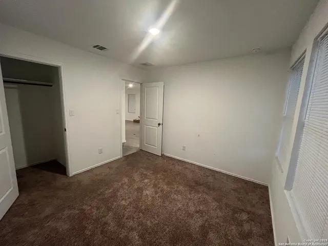 an empty room with closet area