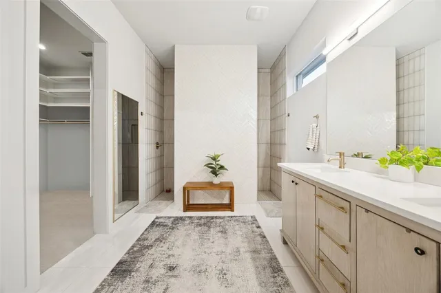 a spacious bathroom with a granite countertop sink and a mirror