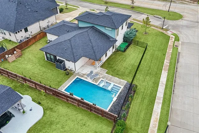 an aerial view of a house with a garden and swimming pool