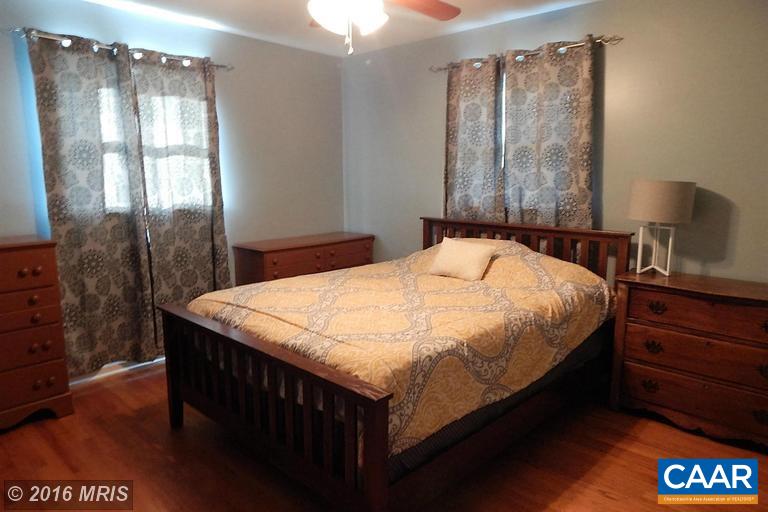 1822 James City Road Reva, VA 22735 - Photo 8 of 11 a bedroom with a bed and a table in it