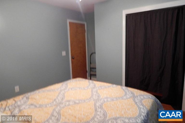 1822 James City Road Reva, VA 22735 - Photo 10 of 11 a bedroom with a bed and a wall painting