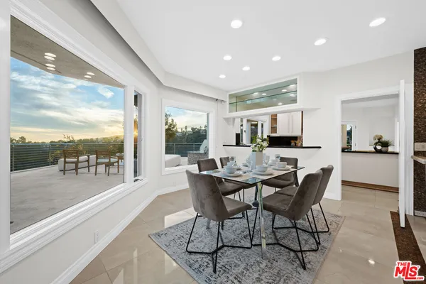 a view of a dining room with furniture and window