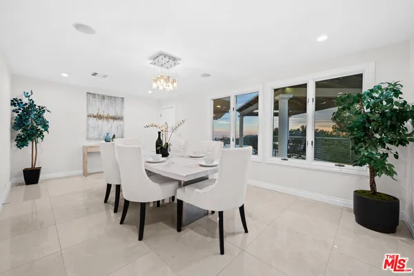a kitchen with refrigerator a sink and white cabinets