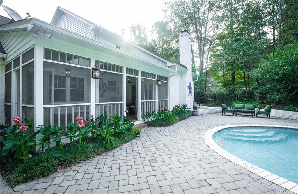 3256 Gray Moss Road Charlotte, NC 28270 - Photo 22 of 35 a view of a house with potted plants and a large tree