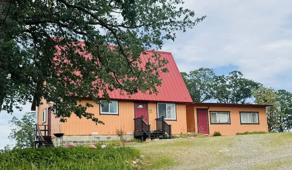 front view of a house with a tree