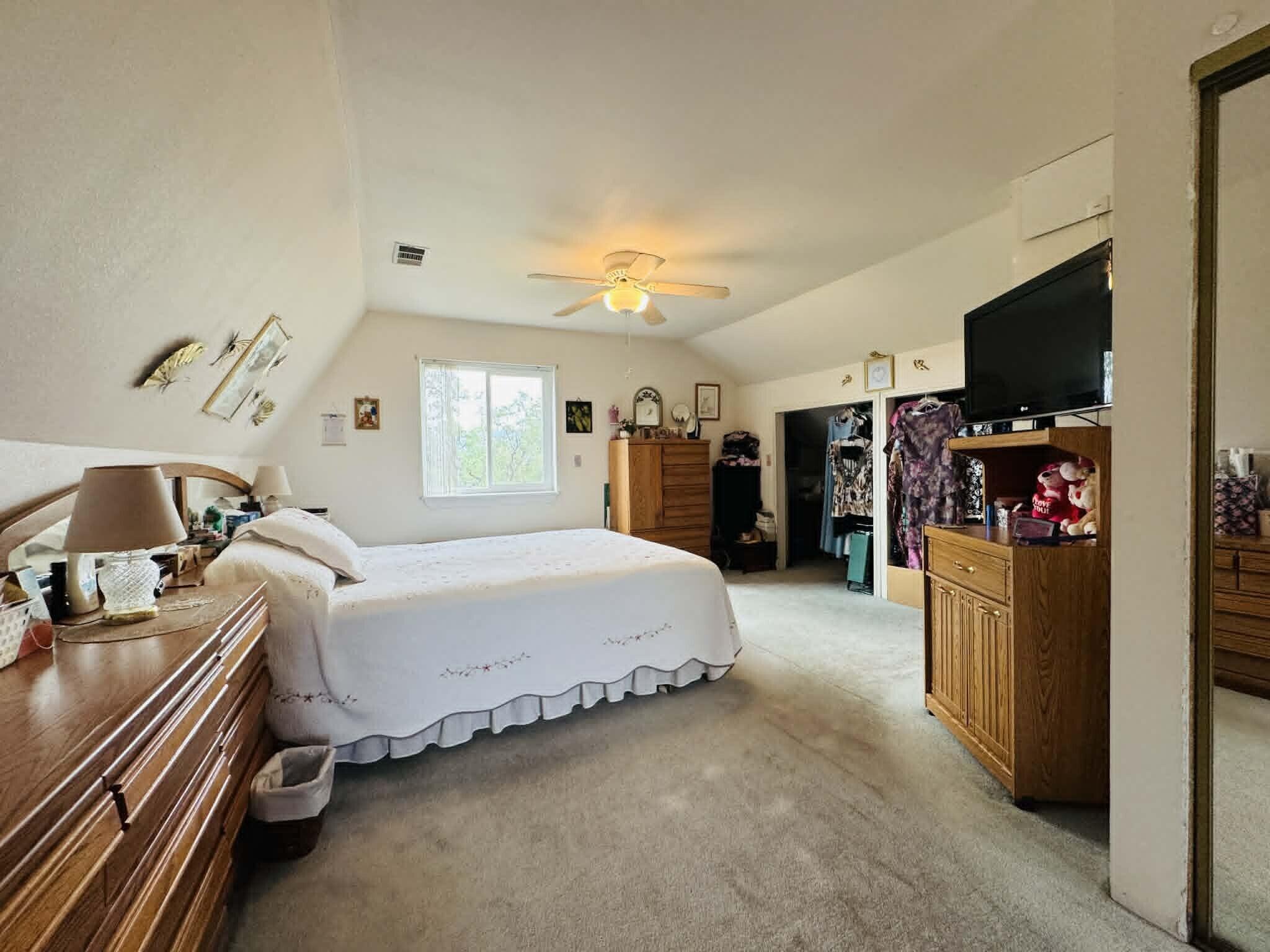 6231 Ridgetop Road Anderson, CA 96007 - Photo 35 of 49 a spacious bedroom with a bed and a flat screen tv