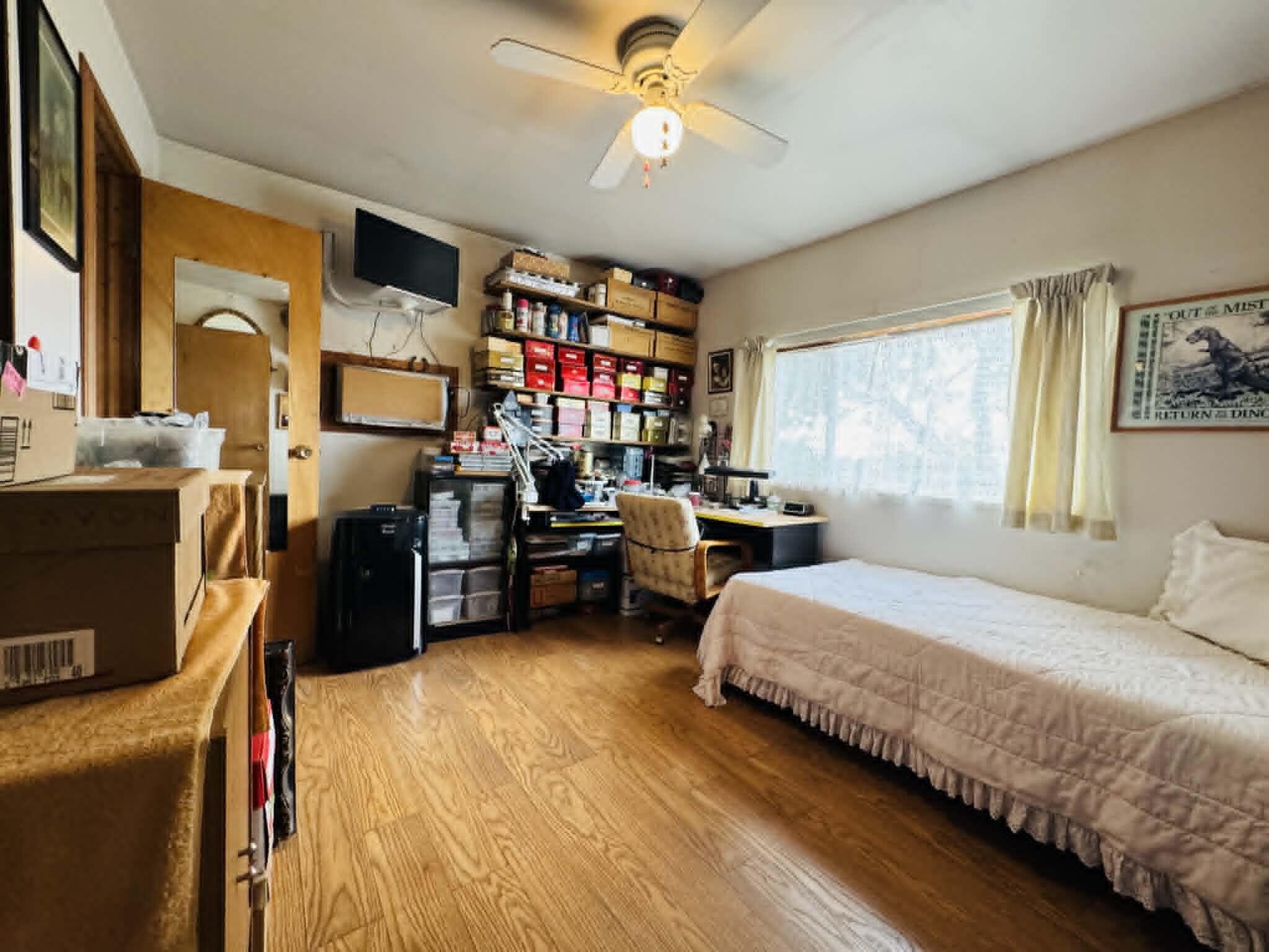 6231 Ridgetop Road Anderson, CA 96007 - Photo 39 of 49 a bedroom with bed and a chandelier
