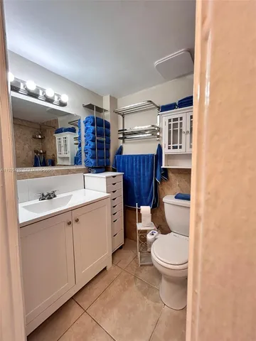 a room with a toilet sink and mirror