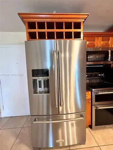 a kitchen with stainless steel appliances granite countertop a refrigerator and a stove