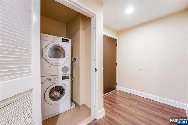 an empty room with wooden floor & closet
