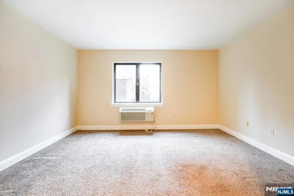 a view of an empty room and a window