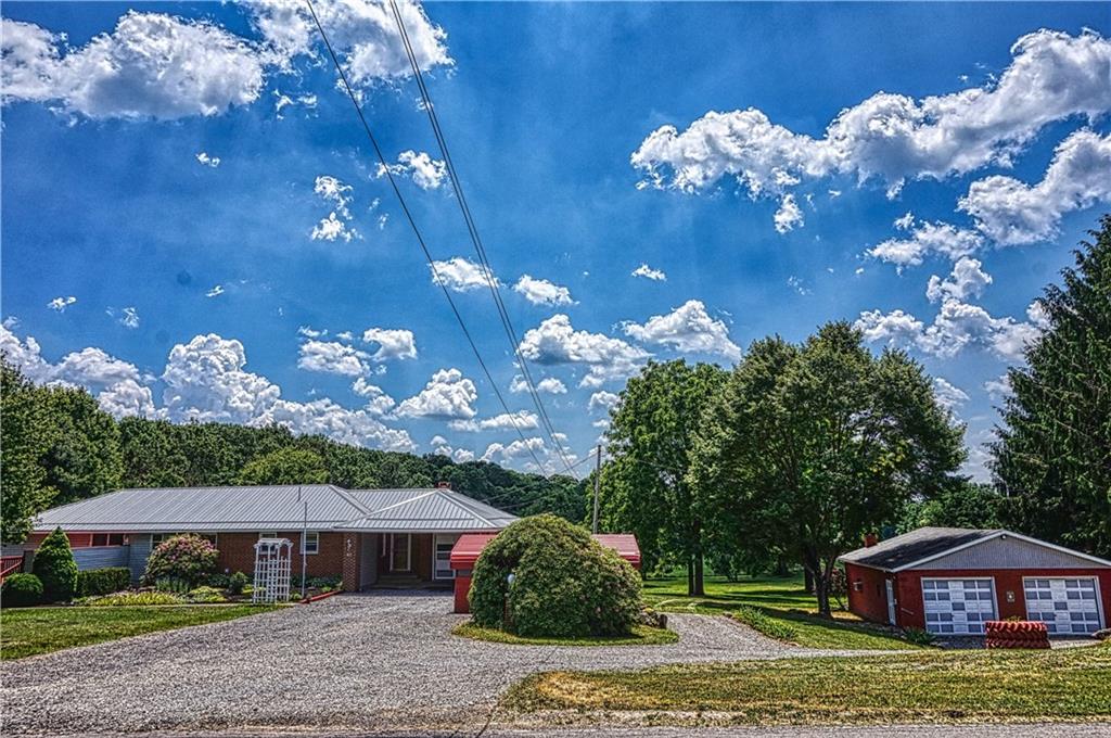 128 West Liberty Road Slippery Rock, PA 16057 - Photo 1 of 25 Ranch style home with 1 stall attached garage, 2 stall carport and 2 stall detached garage (33x33) with 10' doors and full bathroom all situated on 2.49 acres close to Moraine and State Gamelands!