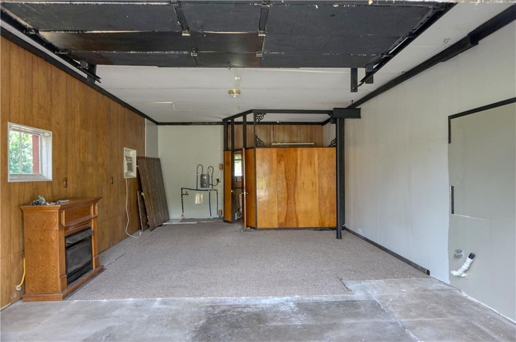 128 West Liberty Road Slippery Rock, PA 16057 - Photo 23 of 25 Garage lovers dream! This 33x33 2 stall detached garage offers a propane fireplace, full bathroom with shower, tank-less hot water heater!