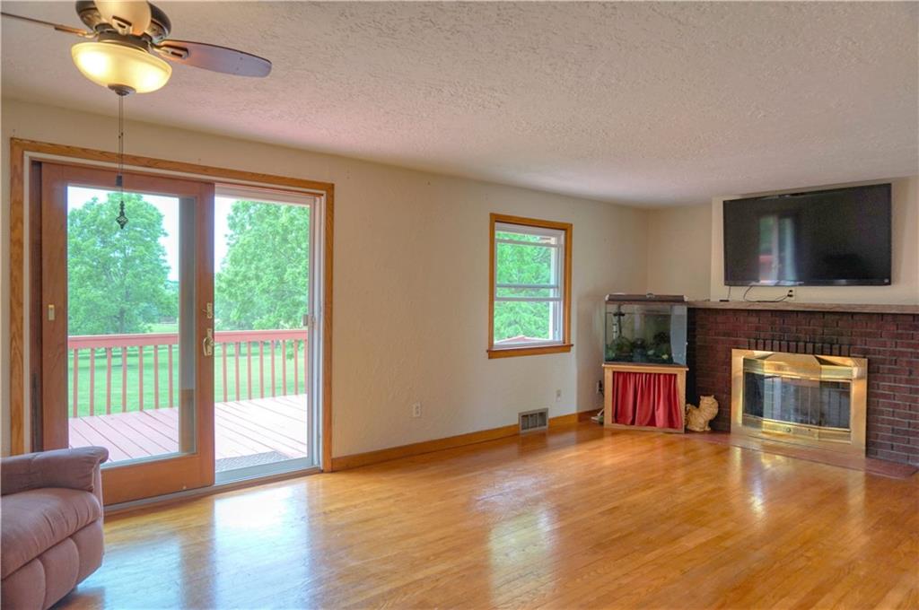 128 West Liberty Road Slippery Rock, PA 16057 - Photo 7 of 25 A sliding door offers access to the large deck overlooking the back yard! A wood burning fireplace in the living area as well!