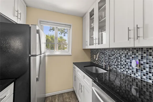 a kitchen with a sink a refrigerator and window
