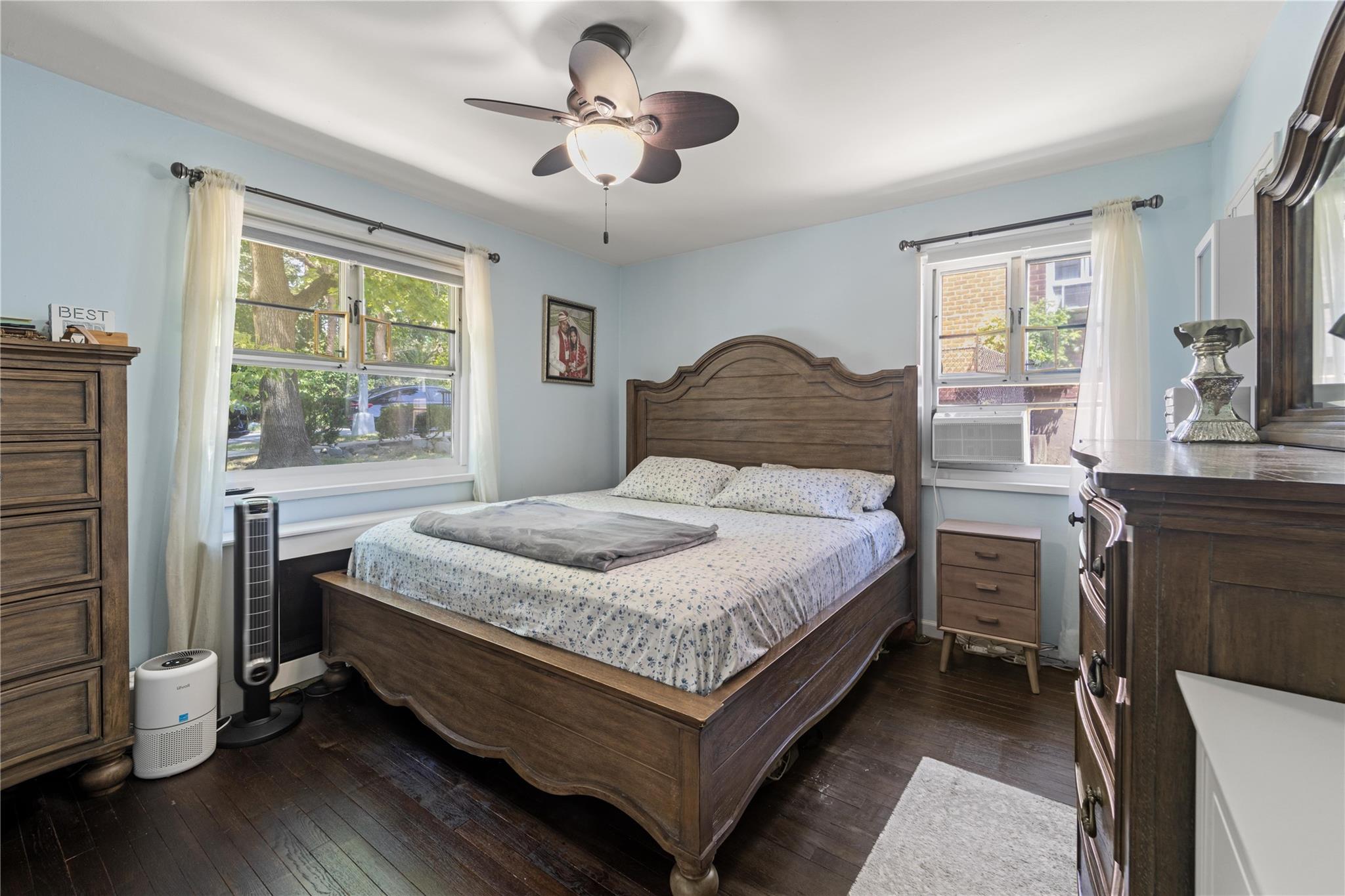 220-06 Stronghurst Avenue, Unit LOWR Queens, NY 11427 - Photo 5 of 19 a bedroom with a bed and a window