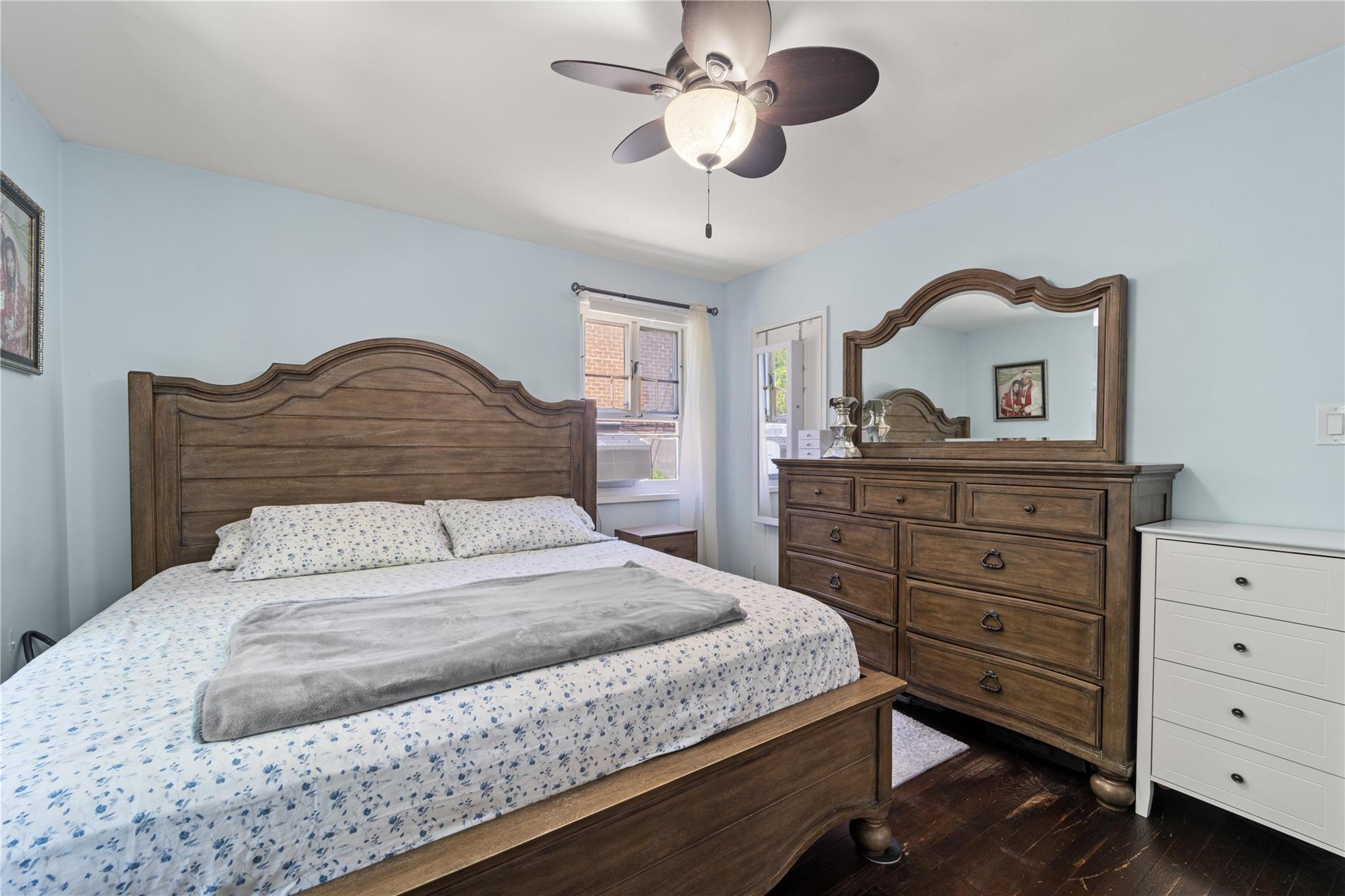 220-06 Stronghurst Avenue, Unit LOWR Queens, NY 11427 - Photo 6 of 19 a bedroom with a bed and a dresser