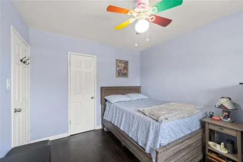 a bedroom with a bed and ceiling fan