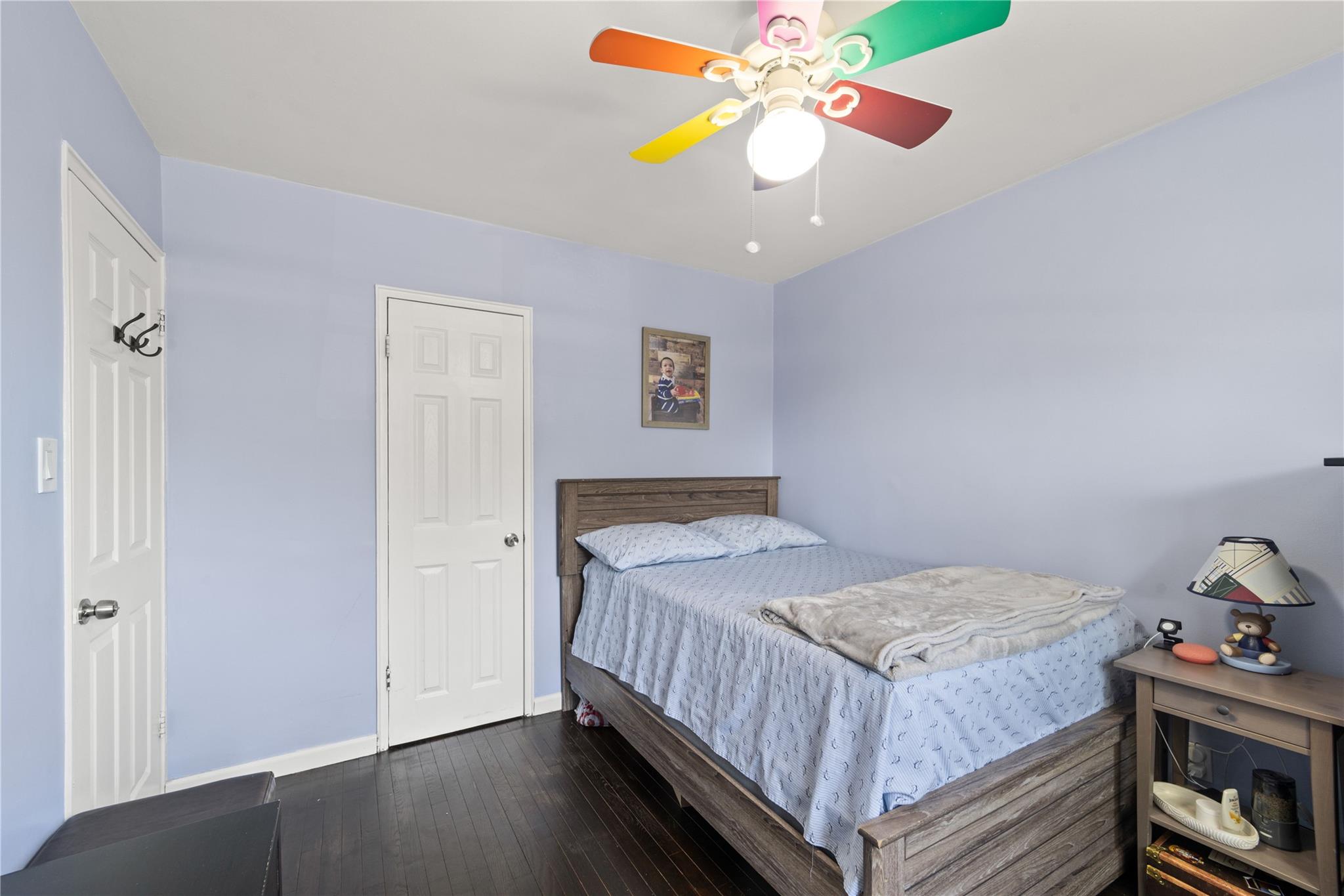220-06 Stronghurst Avenue, Unit LOWR Queens, NY 11427 - Photo 9 of 19 a bedroom with a bed and ceiling fan