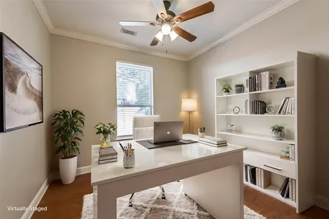 an aerial view of residential houses with outdoor space and trees
