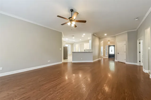 a open kitchen with stainless steel appliances granite countertop a refrigerator a sink dishwasher and a oven with wooden floor