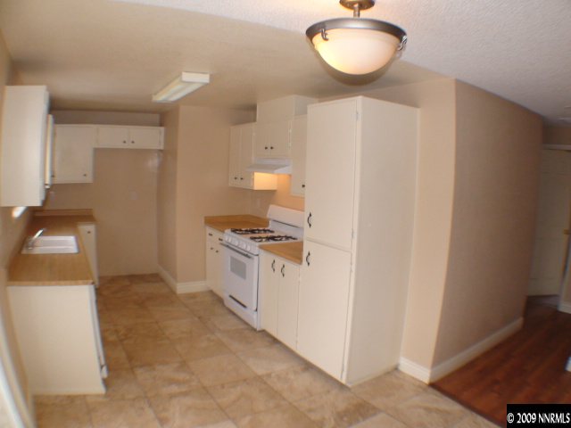 13081 Exinite Drive Reno, NV 89506 - Photo 2 of 9 a kitchen with a sink cabinets and a window