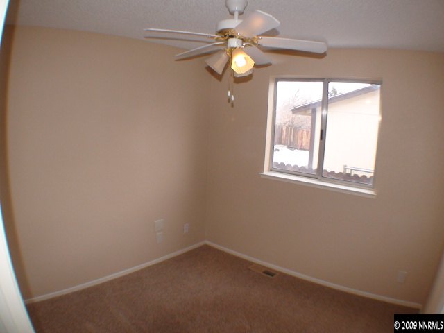 13081 Exinite Drive Reno, NV 89506 - Photo 6 of 9 an empty room with windows and fan