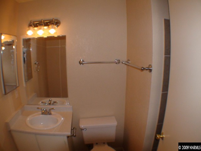 13081 Exinite Drive Reno, NV 89506 - Photo 8 of 9 a bathroom with a sink toilet and shower