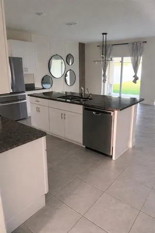 a kitchen with stainless steel appliances granite countertop a sink and a stove