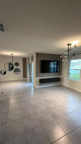 a view of an empty room with a chandelier